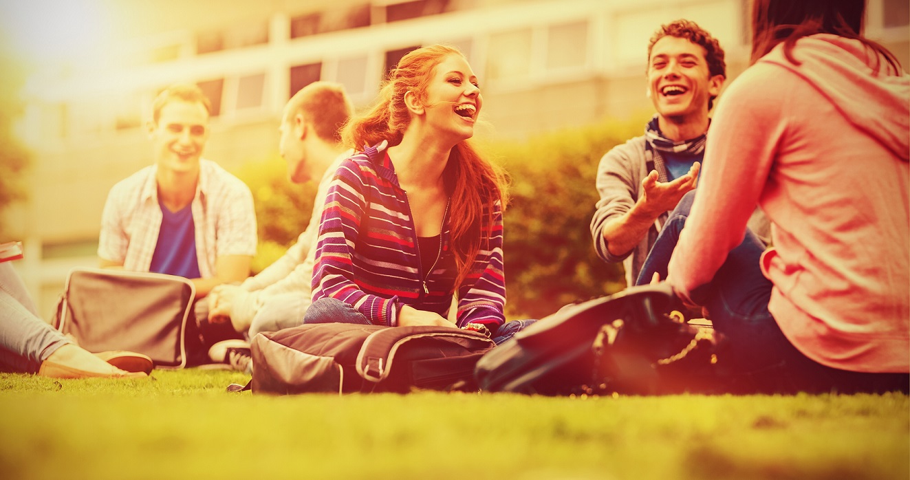 Adolescents assis dehors qui rient