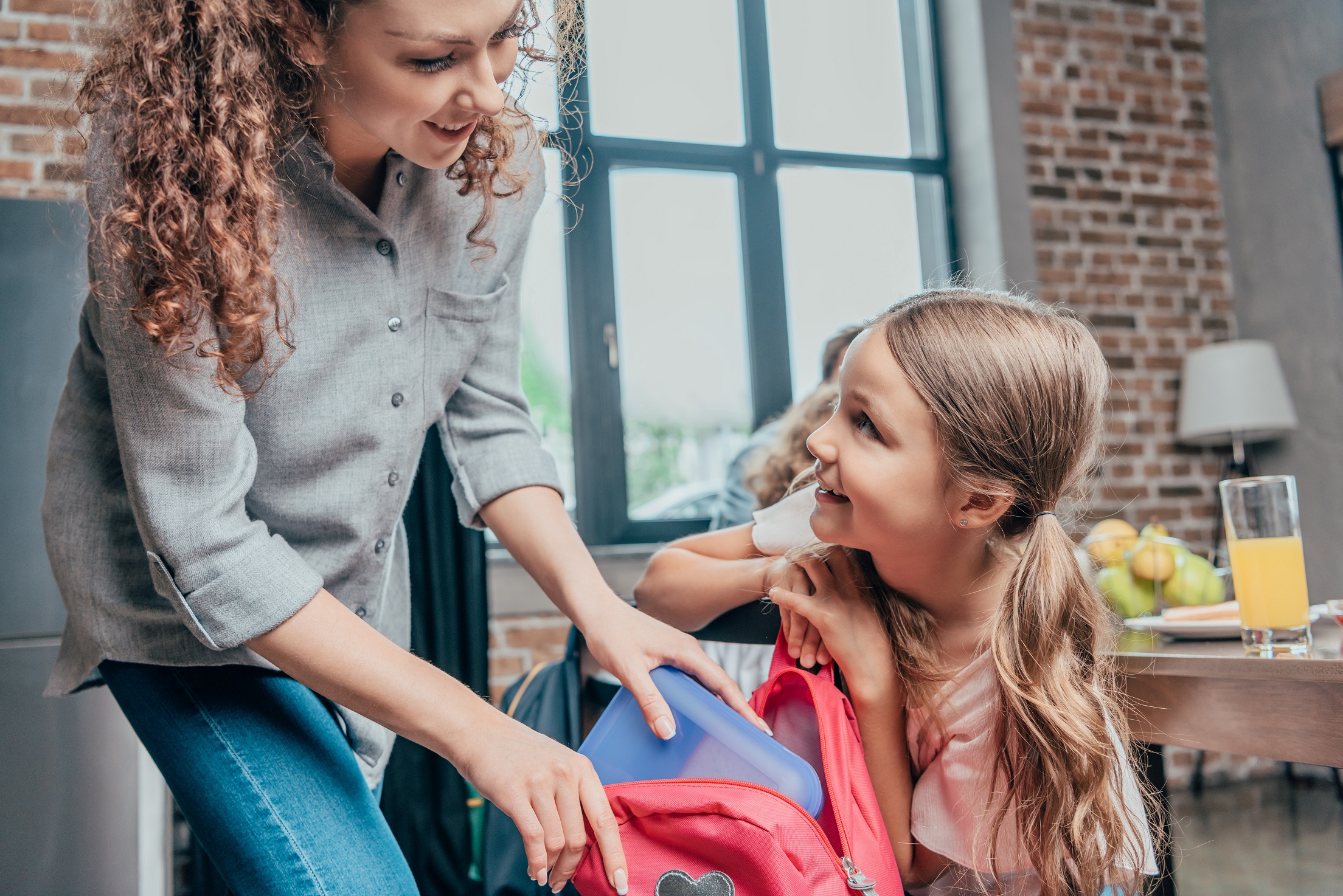 Mother getting her daughter ready for school