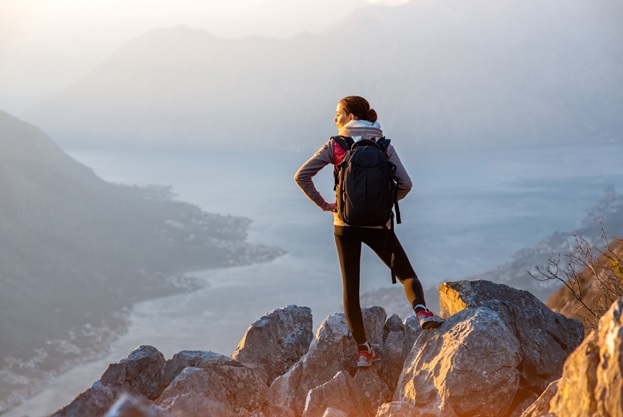 woman at the top of a cliff looking at the view