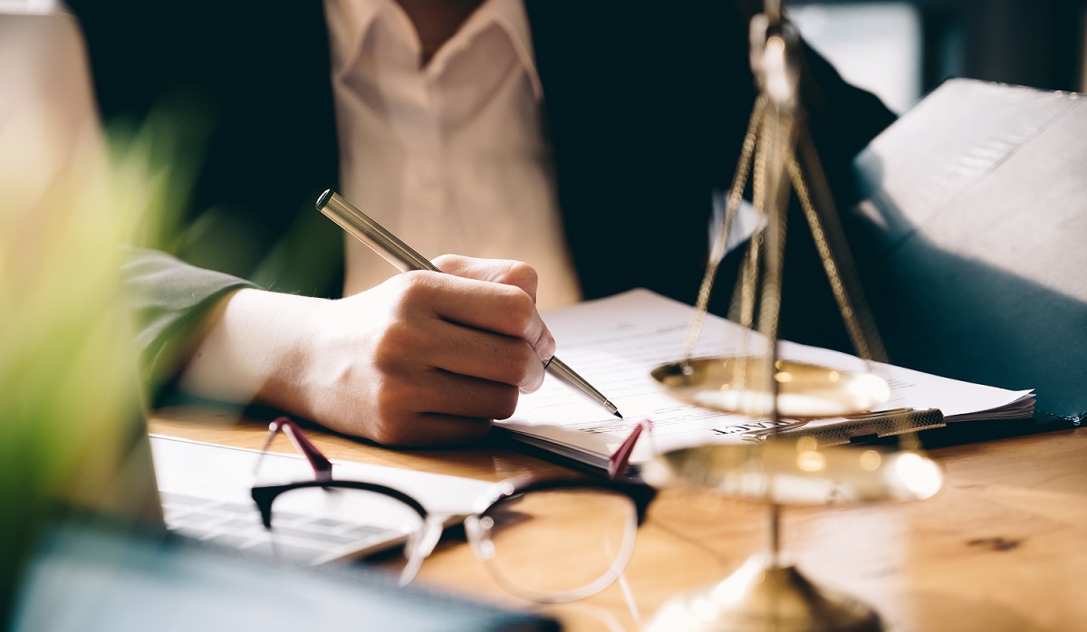 Woman lawyer writing in notebook