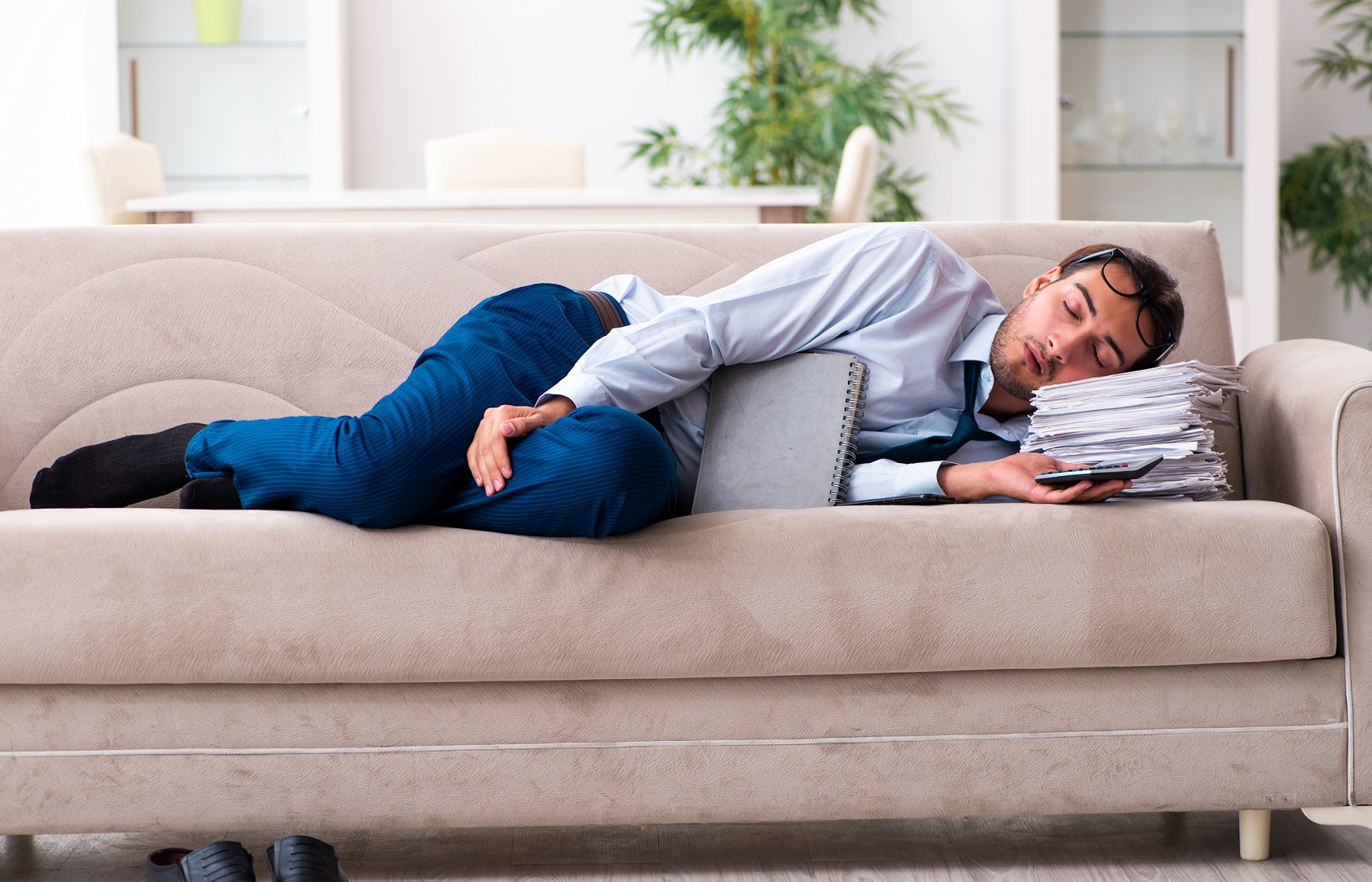 Businessman sleeping on his couch