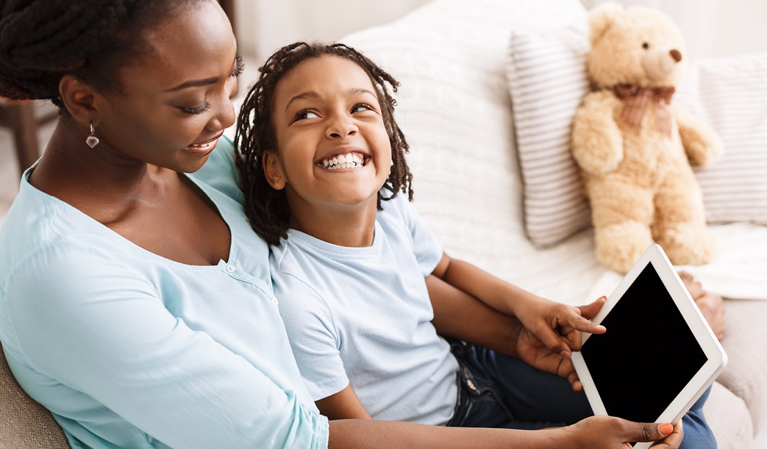 Kid with mom watching tablet