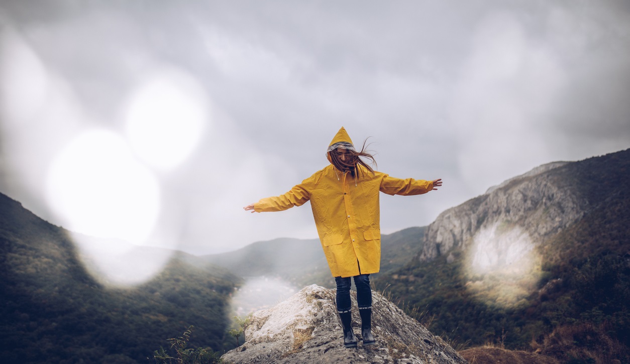 Girl hiking on a mountain in the rain