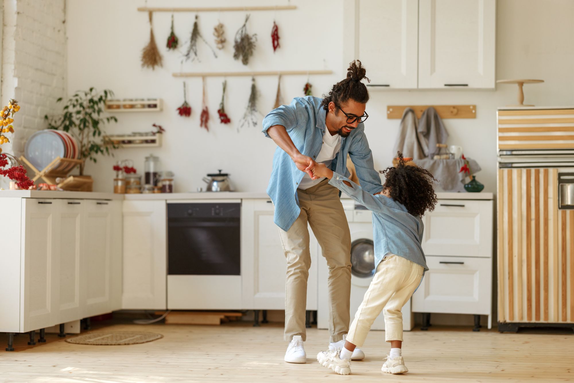 family dancing in the kitchen