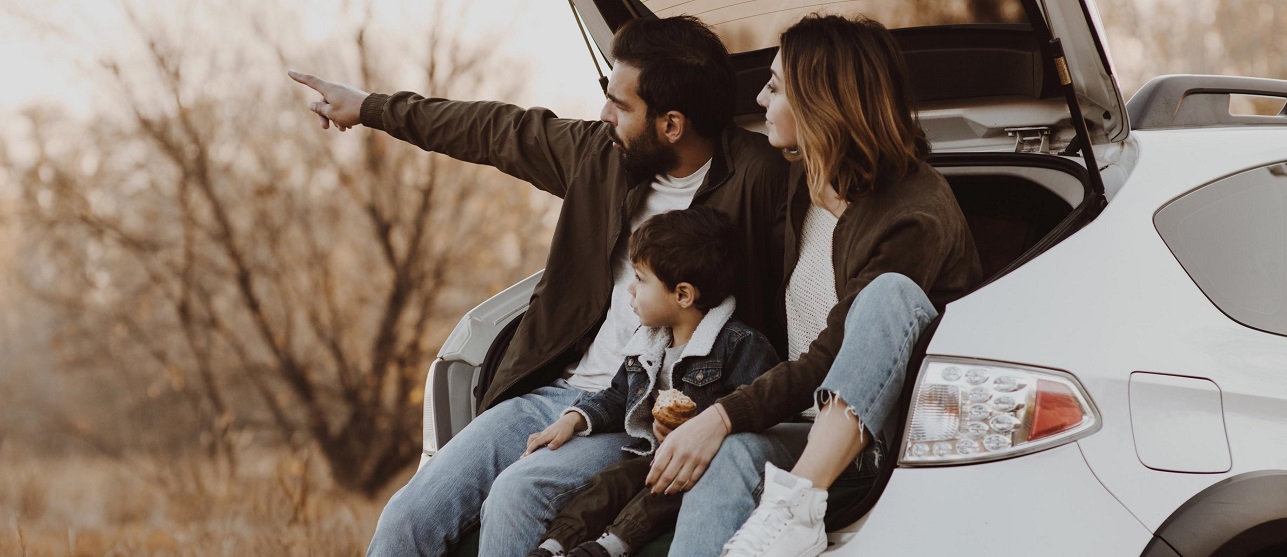 Family sitting at the back of a car