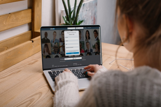 Girl looking at a linkedin page on a laptop