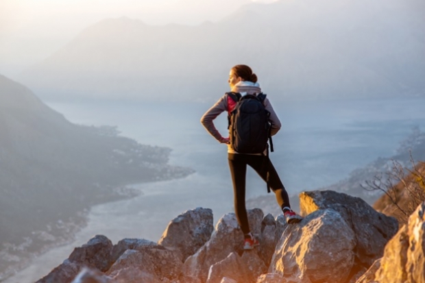 woman at the top of a cliff looking at the view