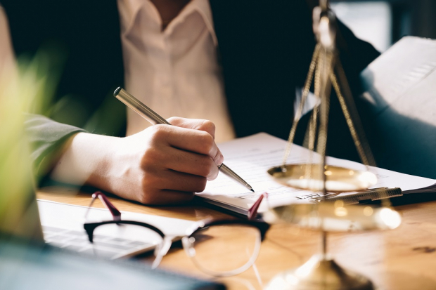 Woman lawyer writing in notebook