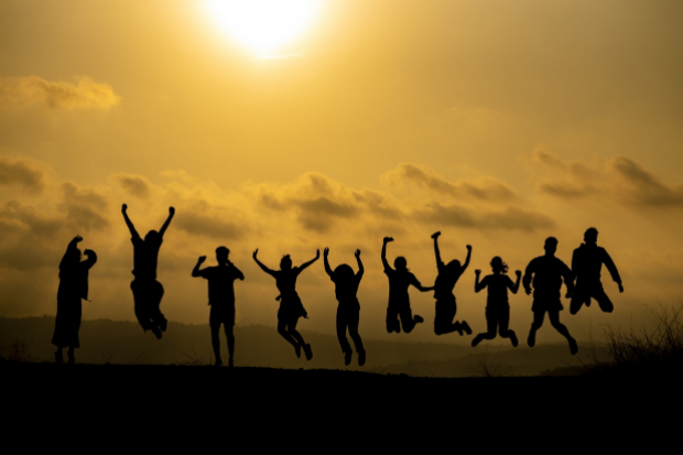 Silhouette of happy people jumping