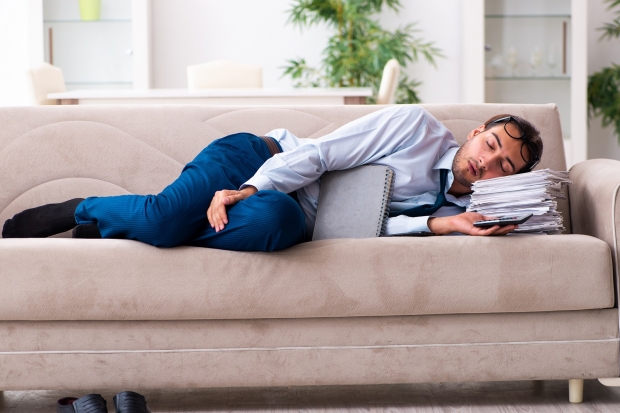 Businessman sleeping on his couch