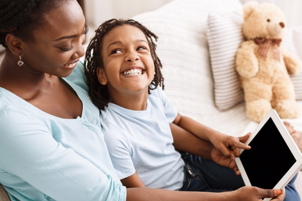 Kid with mom watching tablet