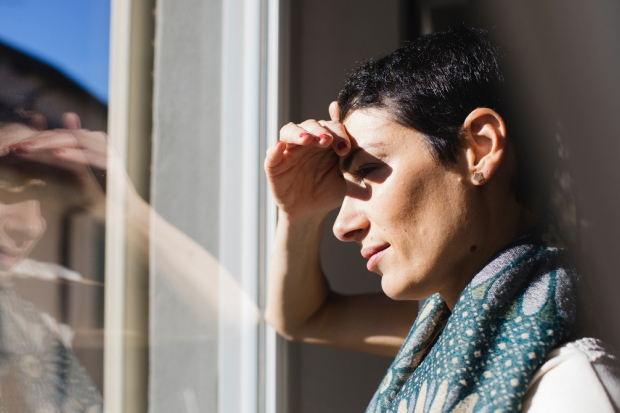 Femme qui regarde par la fenetre