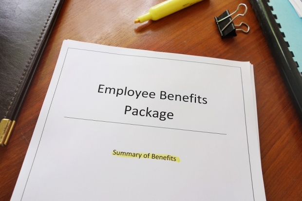 Paper file on a desk entitled Employee Benefits Package