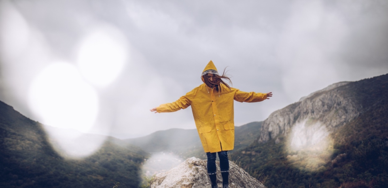 Girl hiking on mountain in the rain