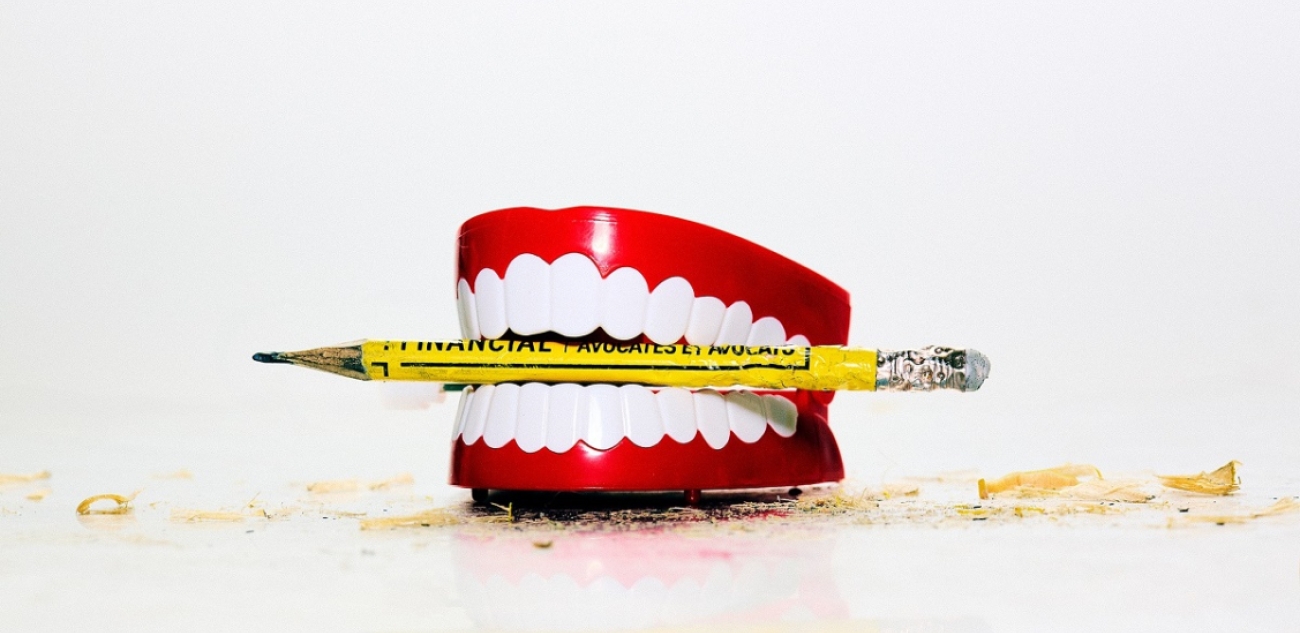 Dentures with yellow crayon between teeth