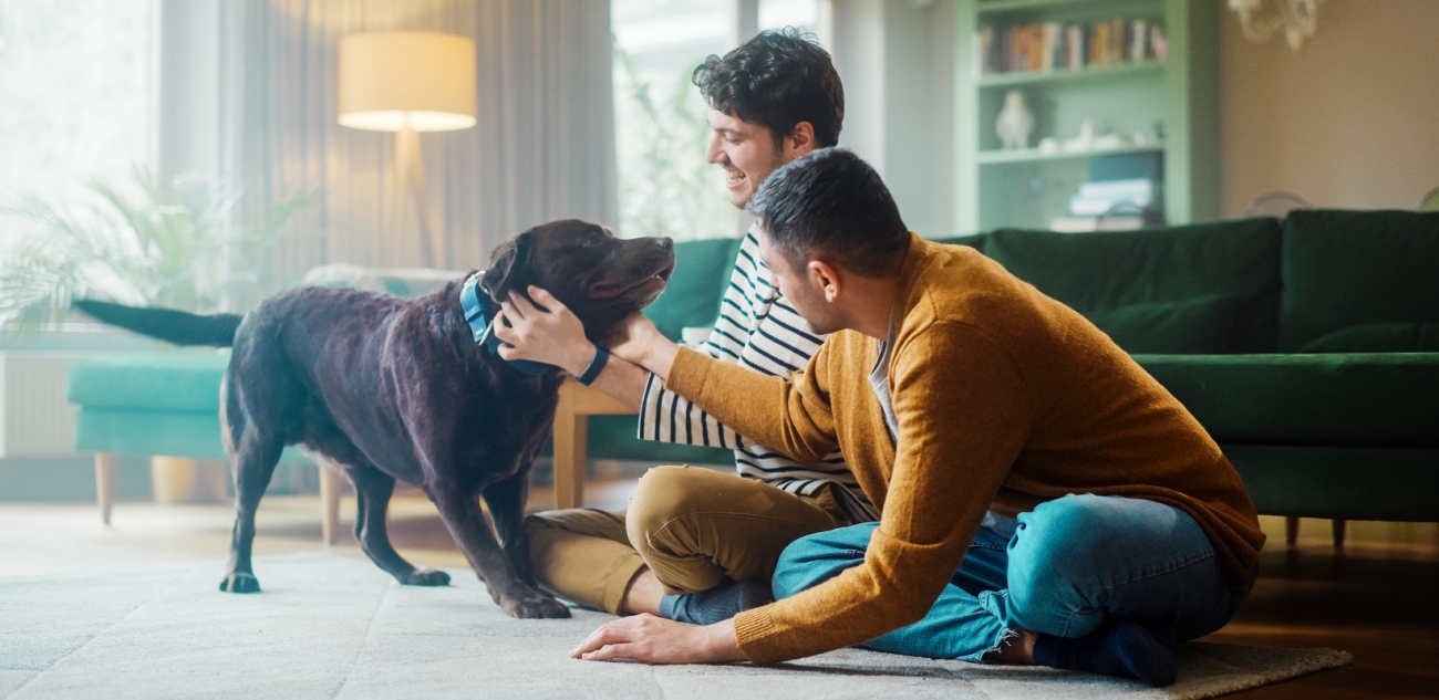 Two men with a dog