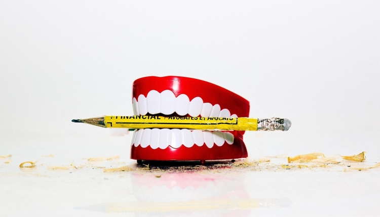 Dentures with yellow crayon between teeth
